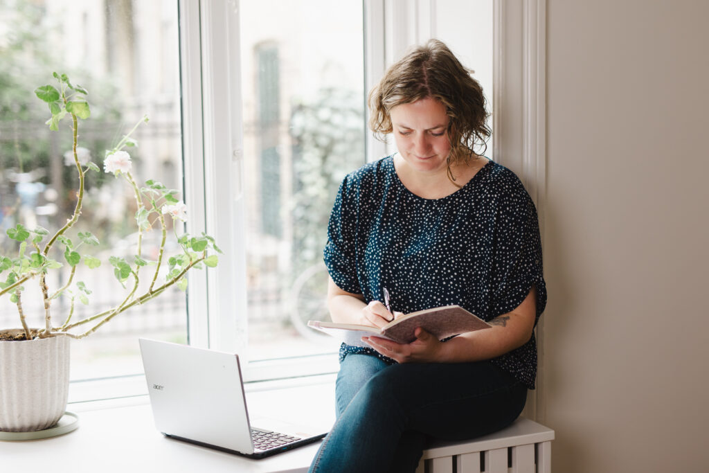 The image for the about me page is a picture of me sitting in a windowsill, making notes in a notebook.